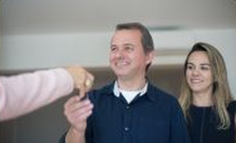 Couple receiving keys to their new home